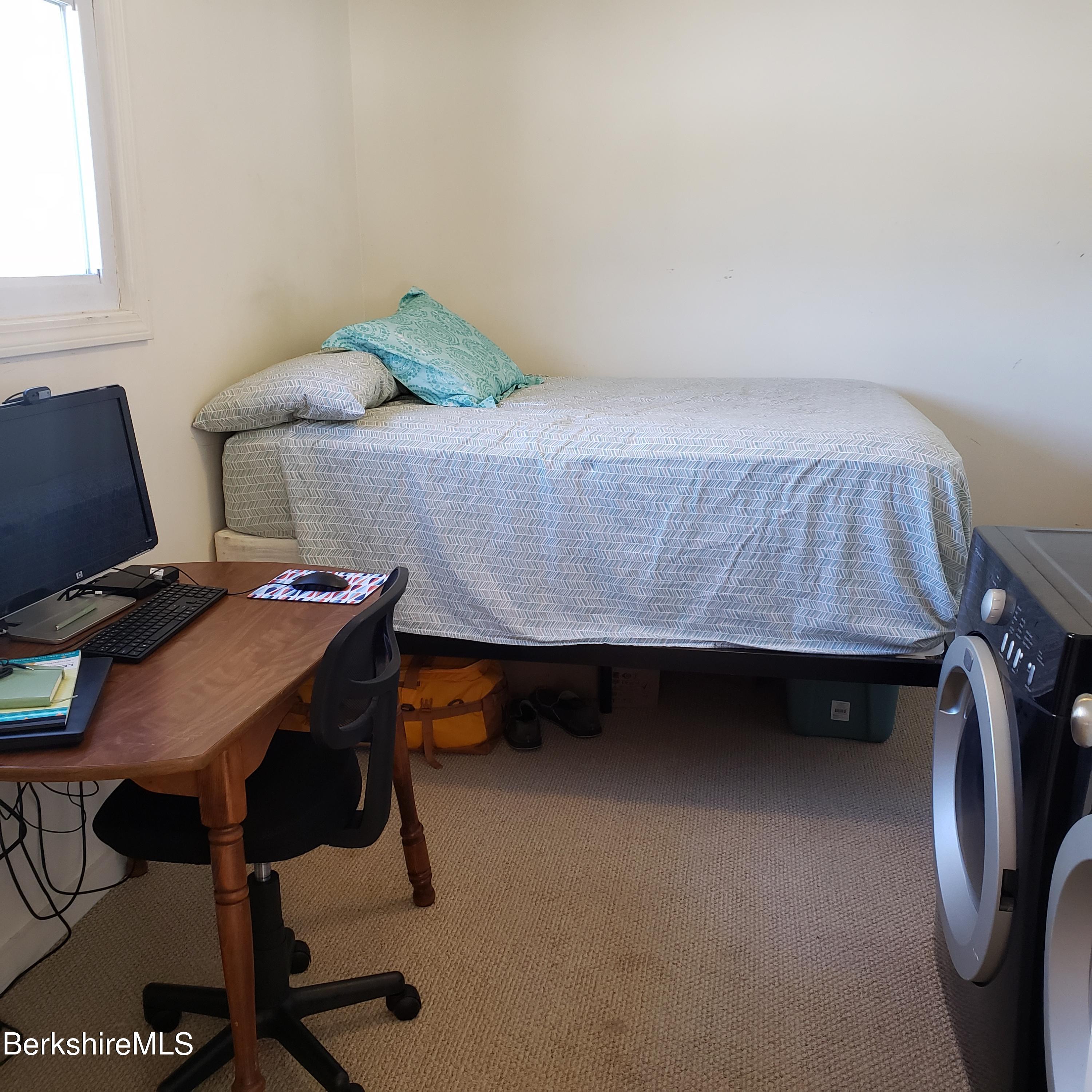 1601 Barber Pond Road Pownal, VT 05261 - Photo 20 of 34 a bedroom with a bed and a desk