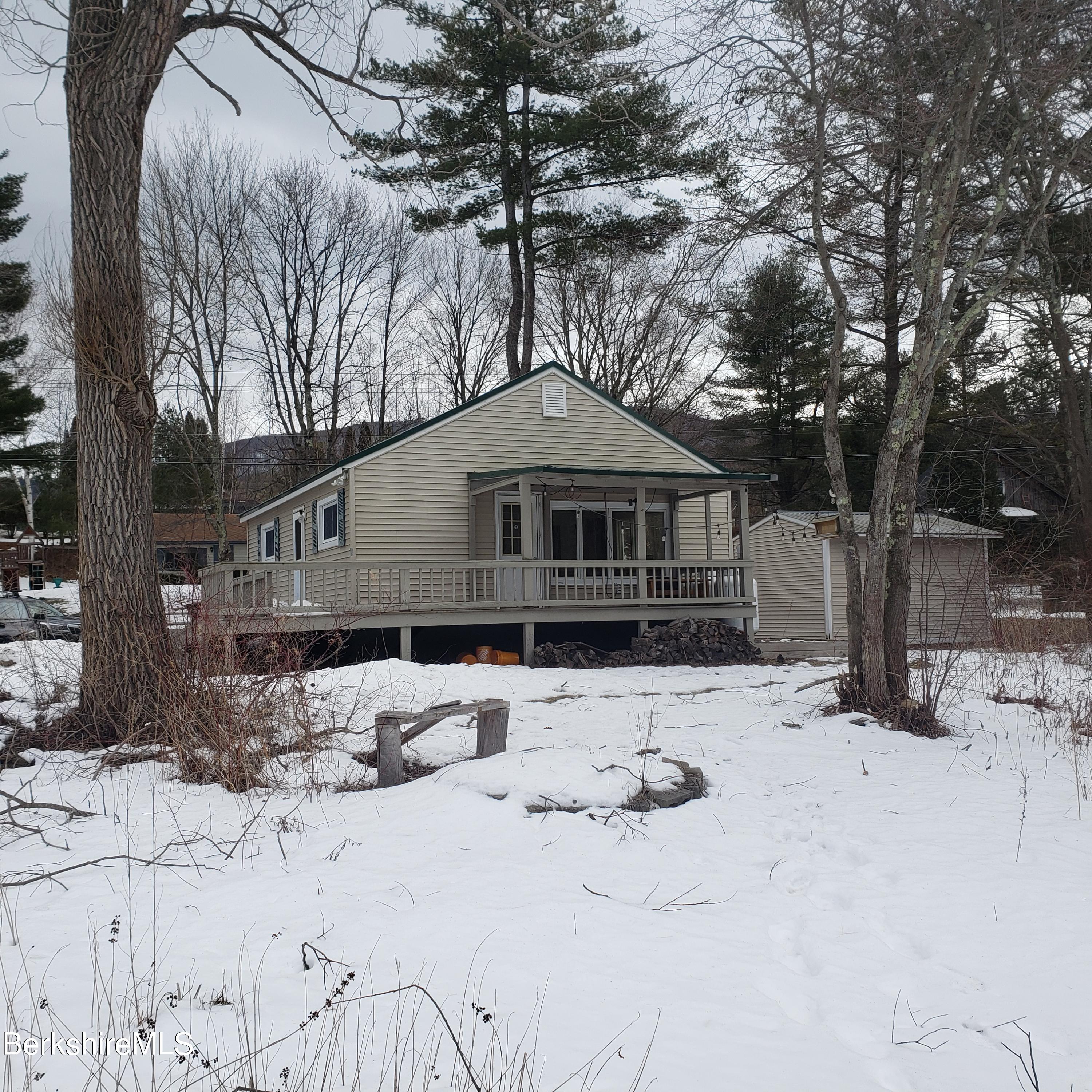 1601 Barber Pond Road Pownal, VT 05261 - Photo 2 of 34 a front view of a house with a yard covered in snow