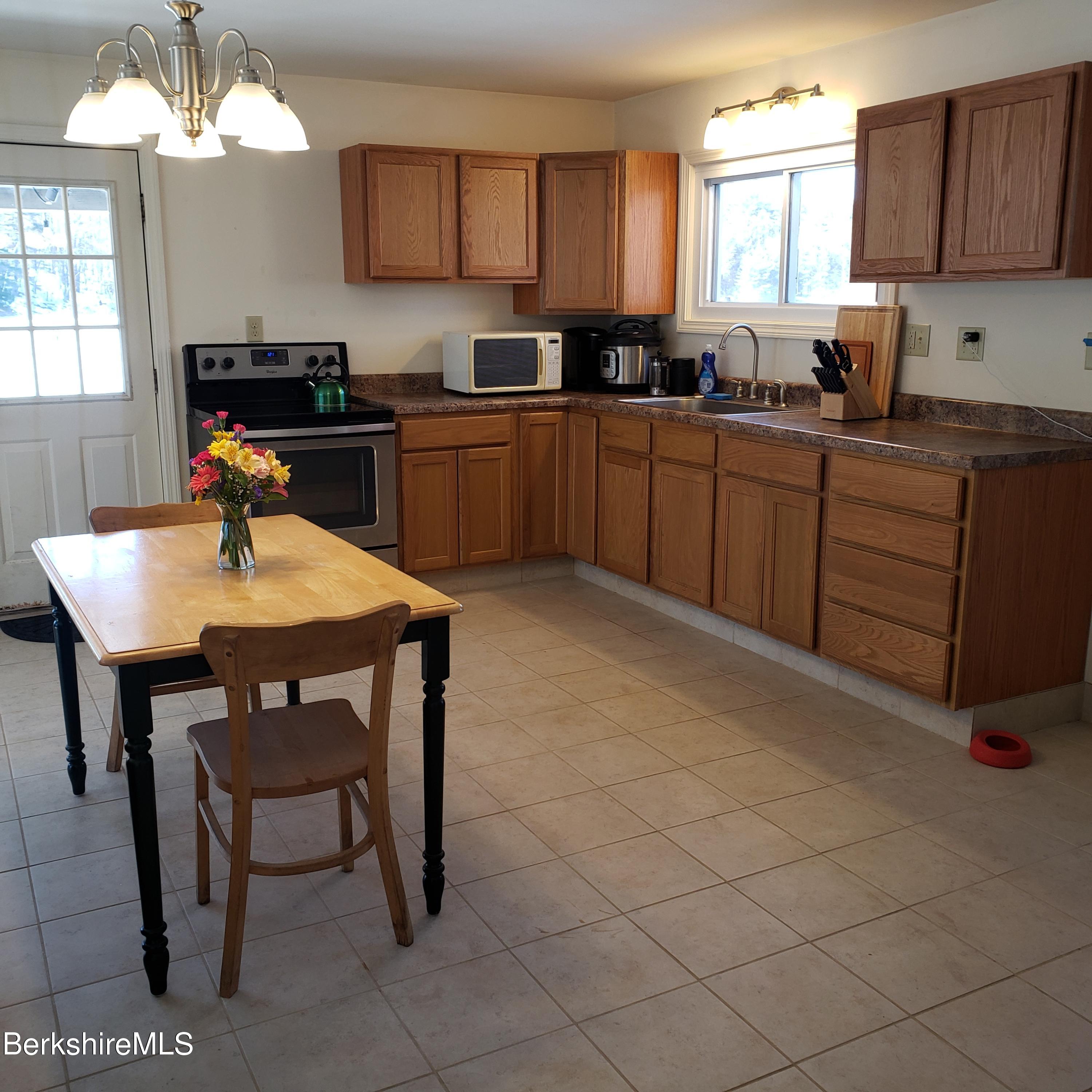 1601 Barber Pond Road Pownal, VT 05261 - Photo 10 of 34 a kitchen with a sink cabinets and window