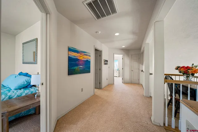 a bedroom with a bed and dresser with window