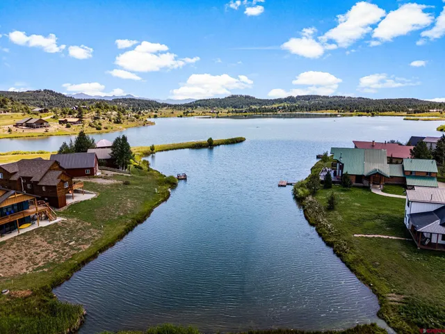 a view of a lake with houses in the back