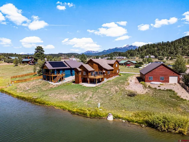 an aerial view of a house with a big yard