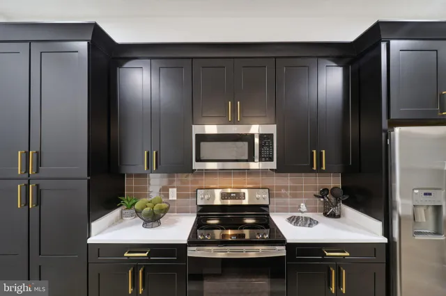 a kitchen with a sink stove and refrigerator
