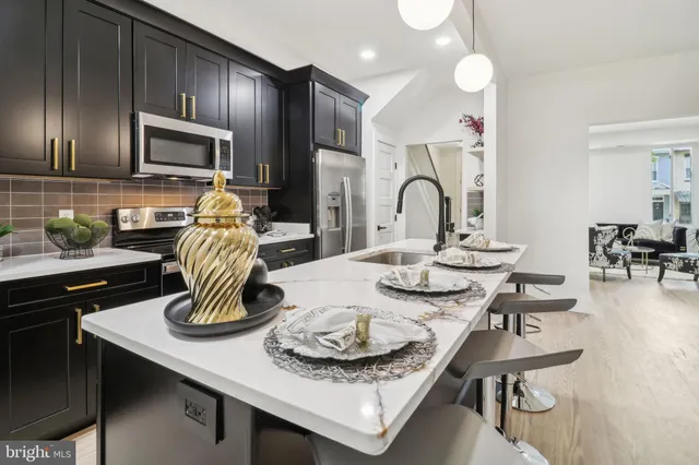 a kitchen with a sink cabinets and stainless steel appliances