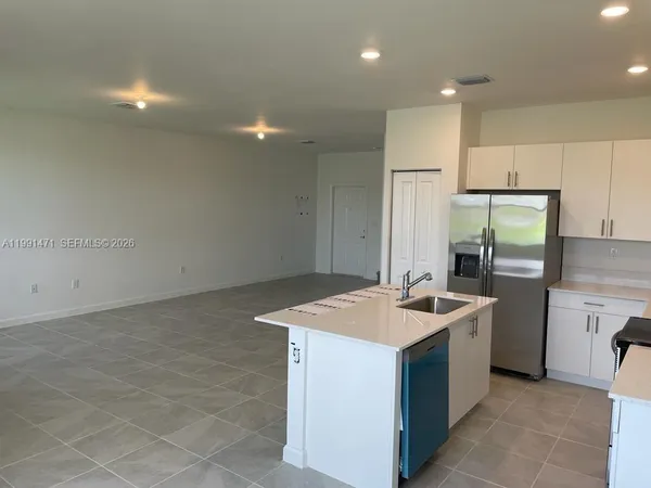 a kitchen with a sink stove and refrigerator