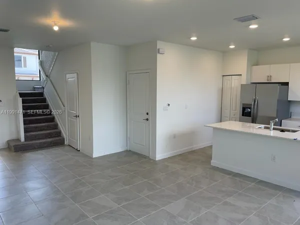 a view of kitchen with cabinets and outdoor space