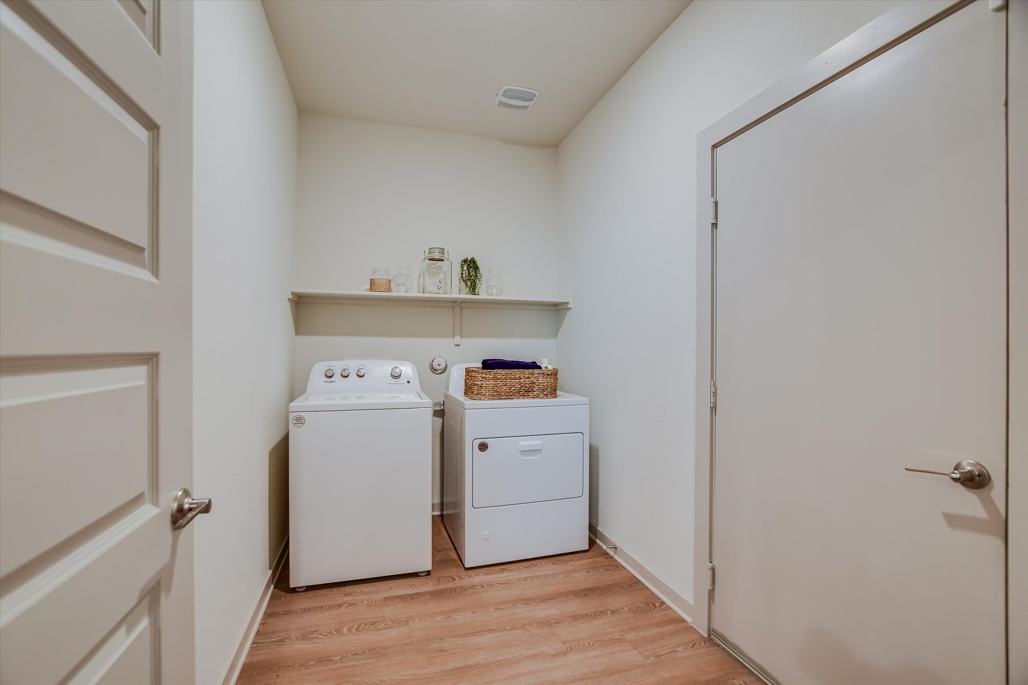 105 Merrick Road Georgetown, TX 78628 - Photo 5 of 23 A dedicated laundry space provides practical amenities with easy-care flooring and convenient shelving.