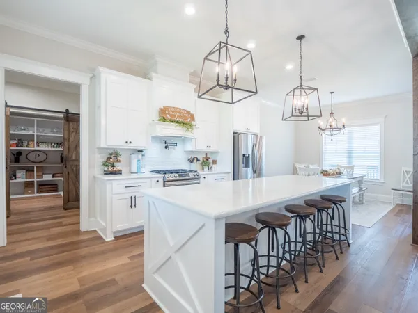 a open kitchen with stainless steel appliances granite countertop a lot of counter space and wooden floors