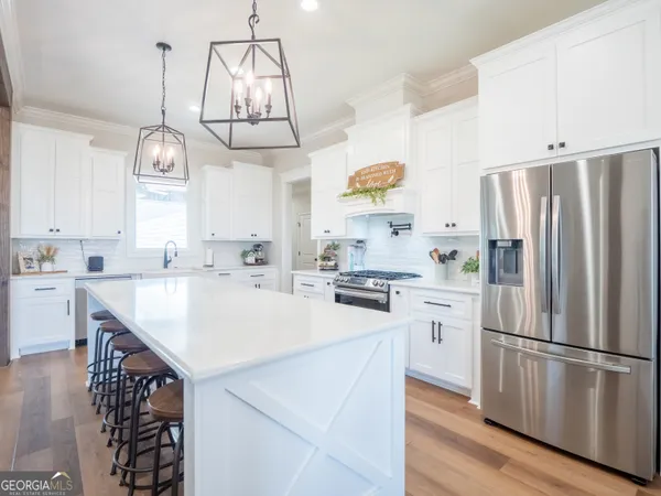 a kitchen with stainless steel appliances granite countertop a stove and a sink