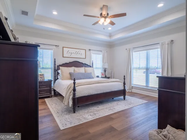 a spacious bathroom with a double vanity sink and mirror with shower