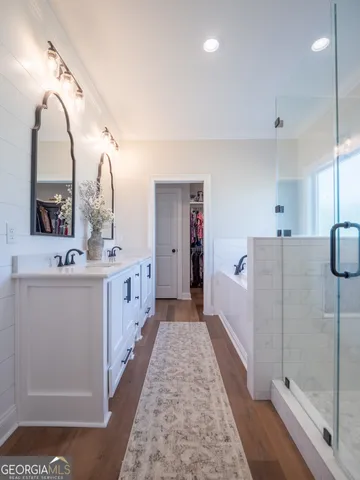 a view of a hallway with wooden floor and furniture