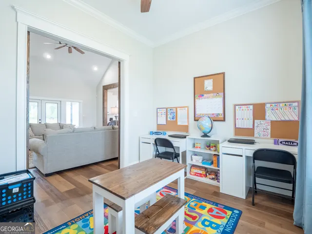 a living room with furniture and a baby crib