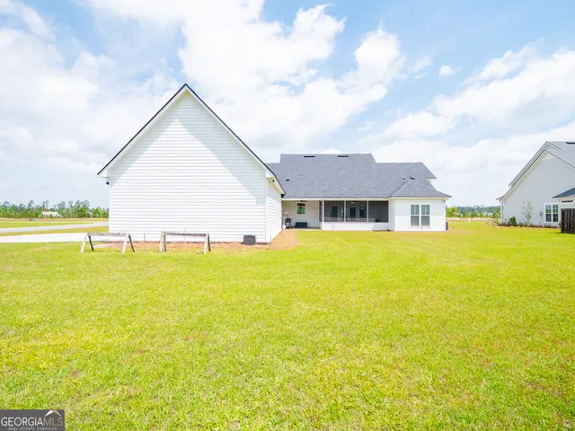 an aerial view of a house with outdoor space and lake view