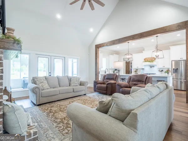 a kitchen with stainless steel appliances a table chairs and wooden floor
