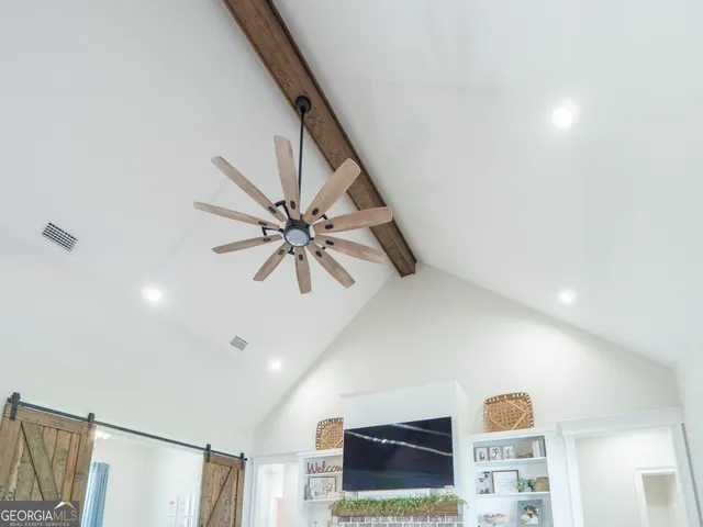 a kitchen with a refrigerator a sink dishwasher a stove and white cabinets with wooden floor