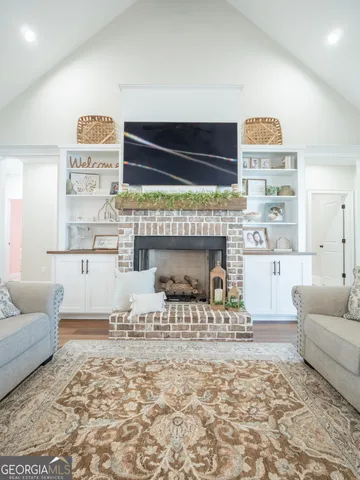 a kitchen with white cabinets and sink