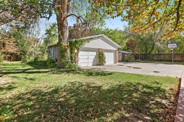 664 Wasatch Street Midvale, UT 84047 - Photo 22 of 33 Detached two-car garage with overhead doors and established trees