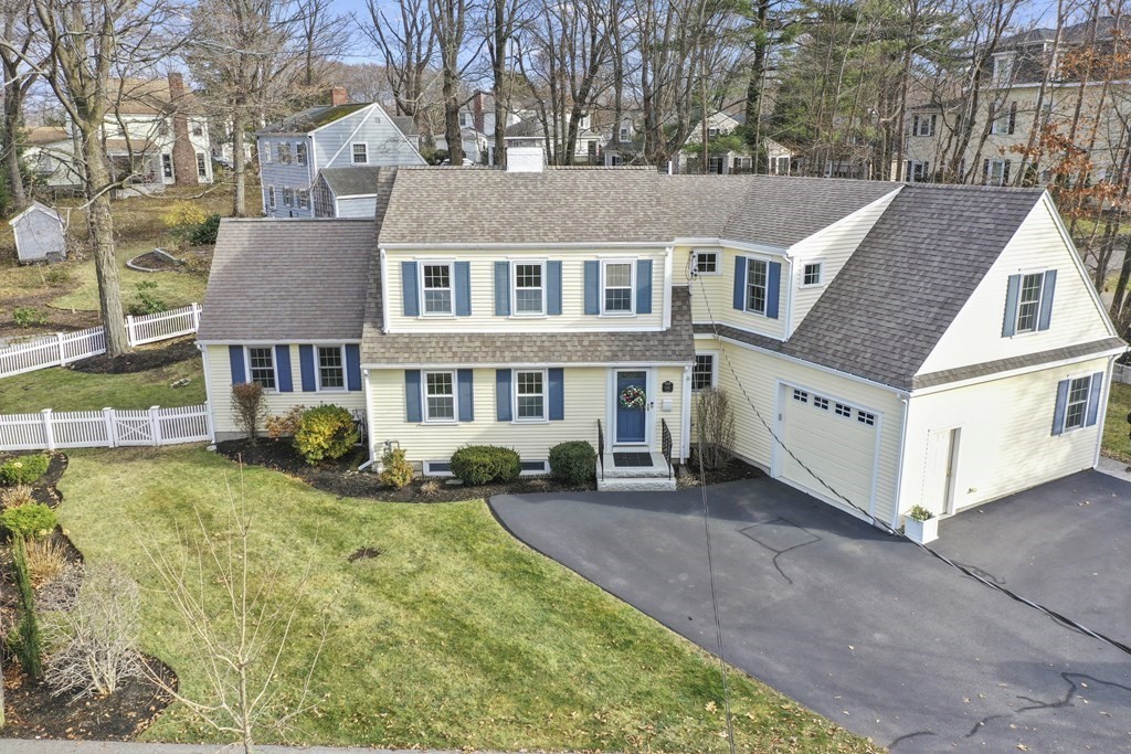 348 Webster Street Needham, MA 02494 - Photo 1 of 42 a view of a white house with large windows and a small yard