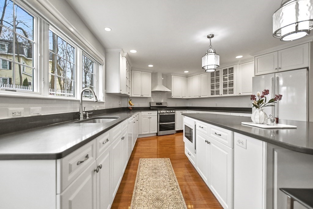 348 Webster Street Needham, MA 02494 - Photo 12 of 42 a large kitchen with granite countertop a sink and cabinets