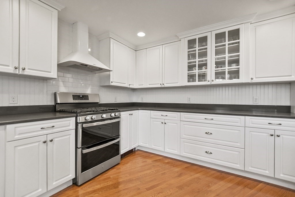 348 Webster Street Needham, MA 02494 - Photo 13 of 42 a kitchen with granite countertop white cabinets stainless steel appliances and sink