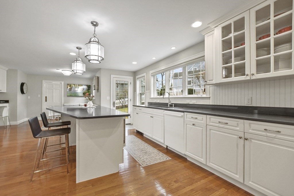 348 Webster Street Needham, MA 02494 - Photo 15 of 42 a open kitchen with granite countertop white cabinets and chandelier