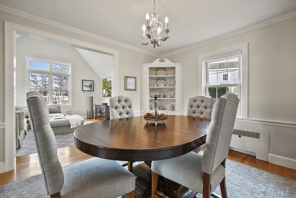 348 Webster Street Needham, MA 02494 - Photo 17 of 42 a dining room with furniture a rug and a chandelier