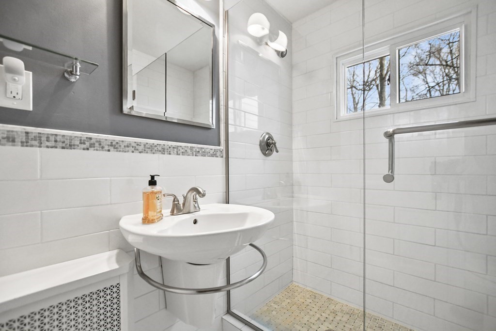 348 Webster Street Needham, MA 02494 - Photo 34 of 42 a bathroom with a sink a mirror and a shower