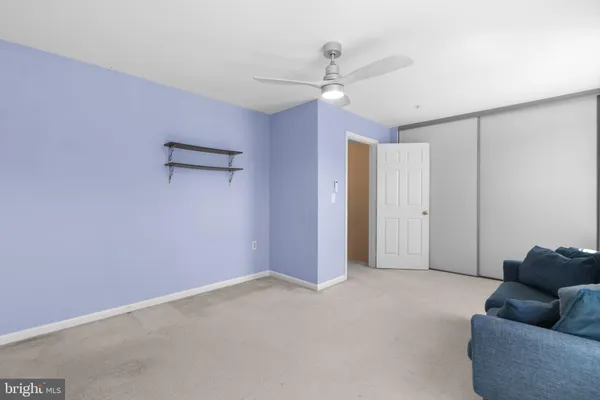 a view of an empty room with a ceiling fan