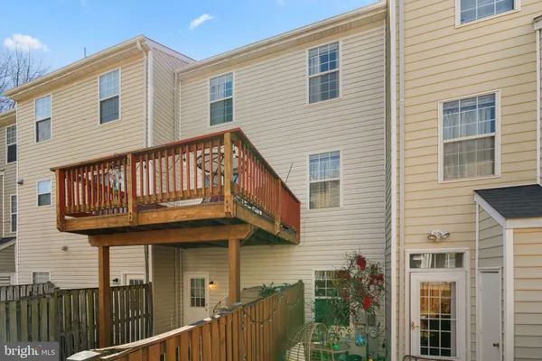 a view of a house with wooden fence
