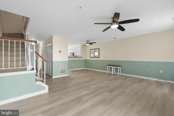 a view of a livingroom with a ceiling fan and window