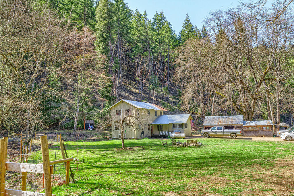 4832 Anderson Creek Road Talent, OR 97540 - Photo 1 of 39 a backyard of a house with a table and chairs