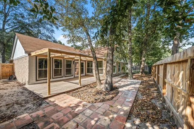 a view of a backyard with wooden fence