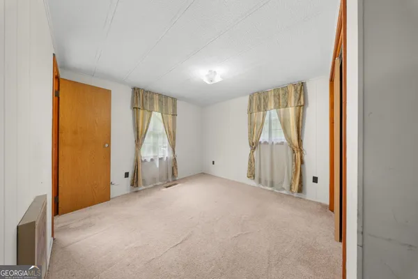 an empty room with a bathroom and a vanity