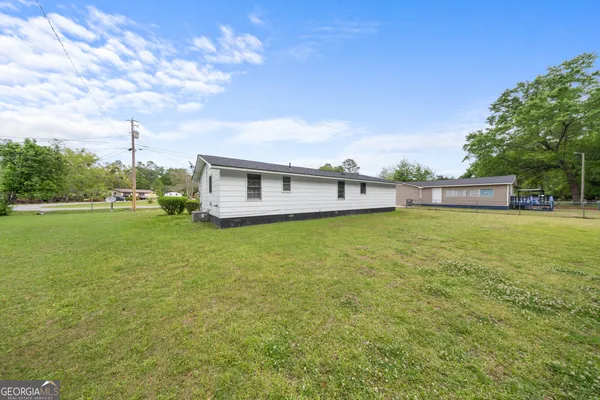 a view of a house with a big yard