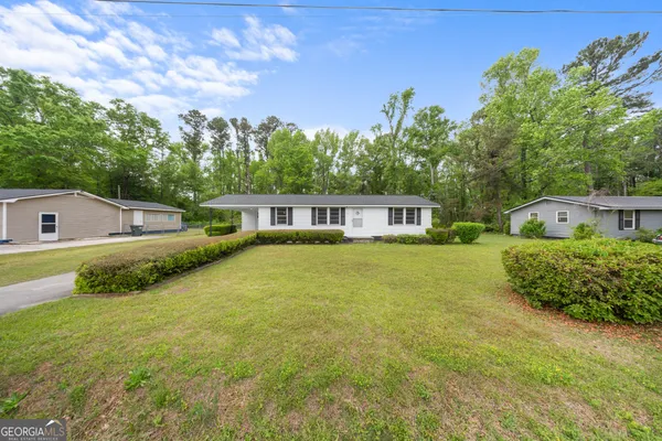 a front view of a house with garden