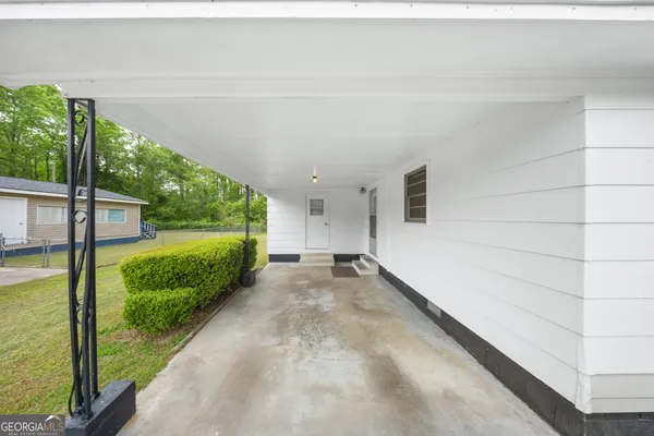 a view of a porch with furniture and garden