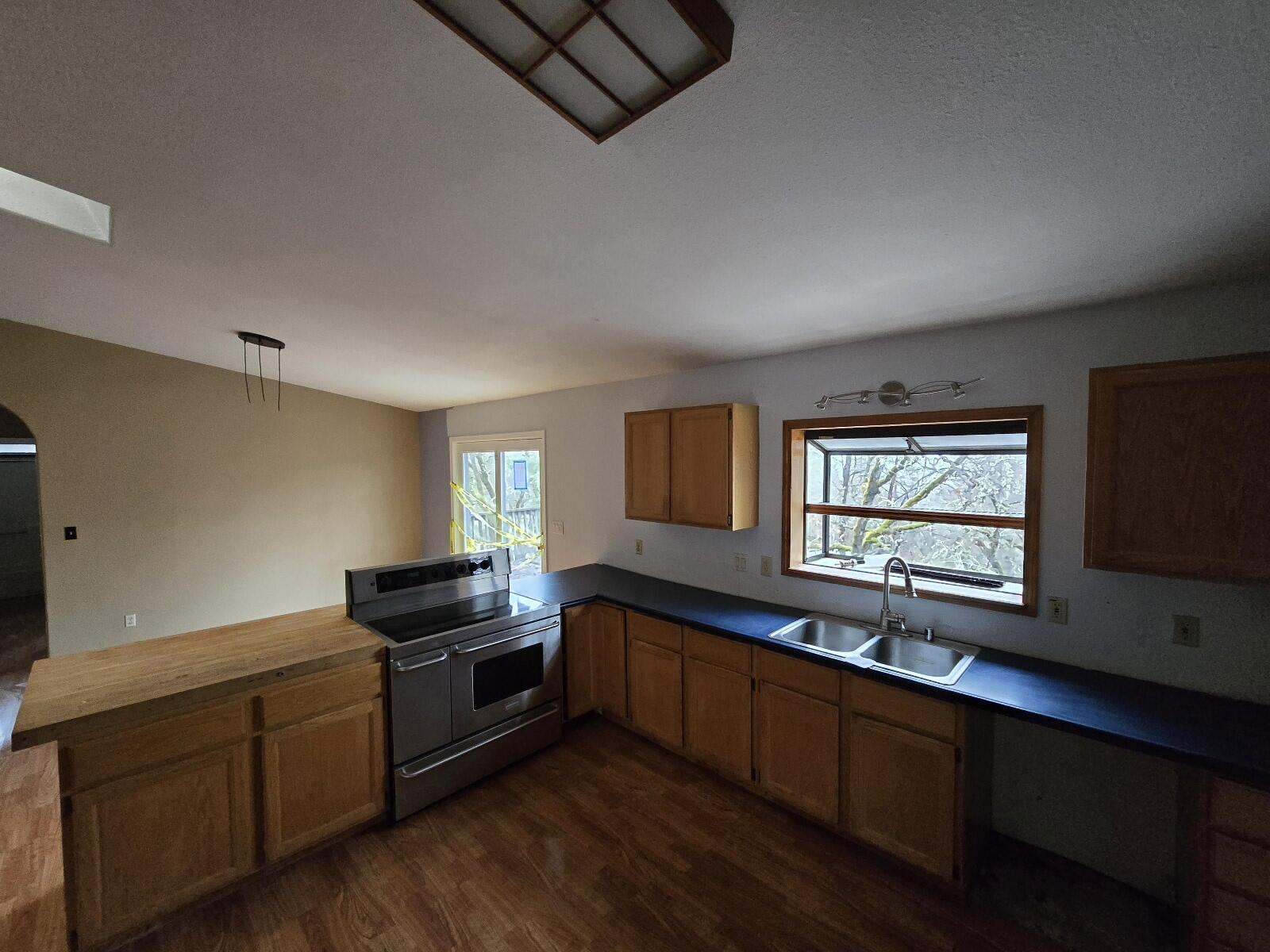 4940 Old Lewiston Road Lewiston, CA 96052 - Photo 13 of 27 a kitchen with stainless steel appliances a sink and a stove