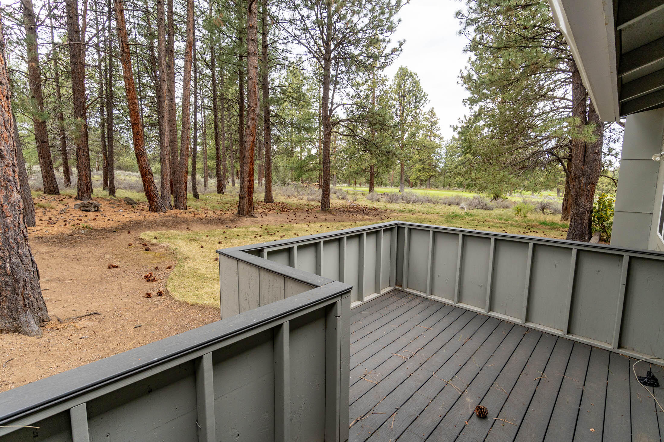 20316 Donkey Sled Road Bend, OR 97702 - Photo 23 of 50 a view of a wooden deck and a backyard
