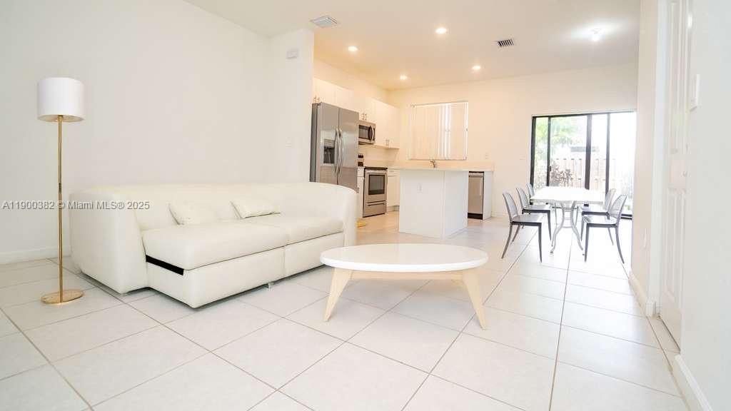 a living room with furniture and white walls