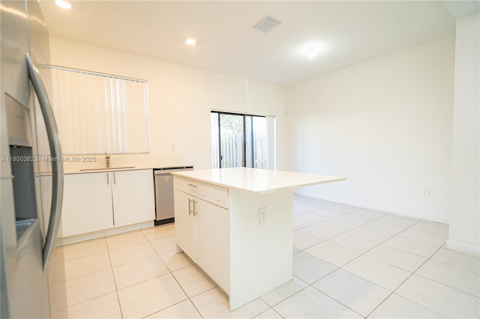13237 Southwest 286th Street, Unit 13237 Homestead, FL 33033 - Photo 19 of 48 a kitchen with granite countertop white cabinets and white appliances