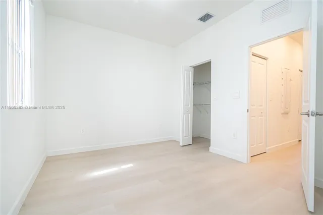 a view of washer and dryer with kitchen in the background