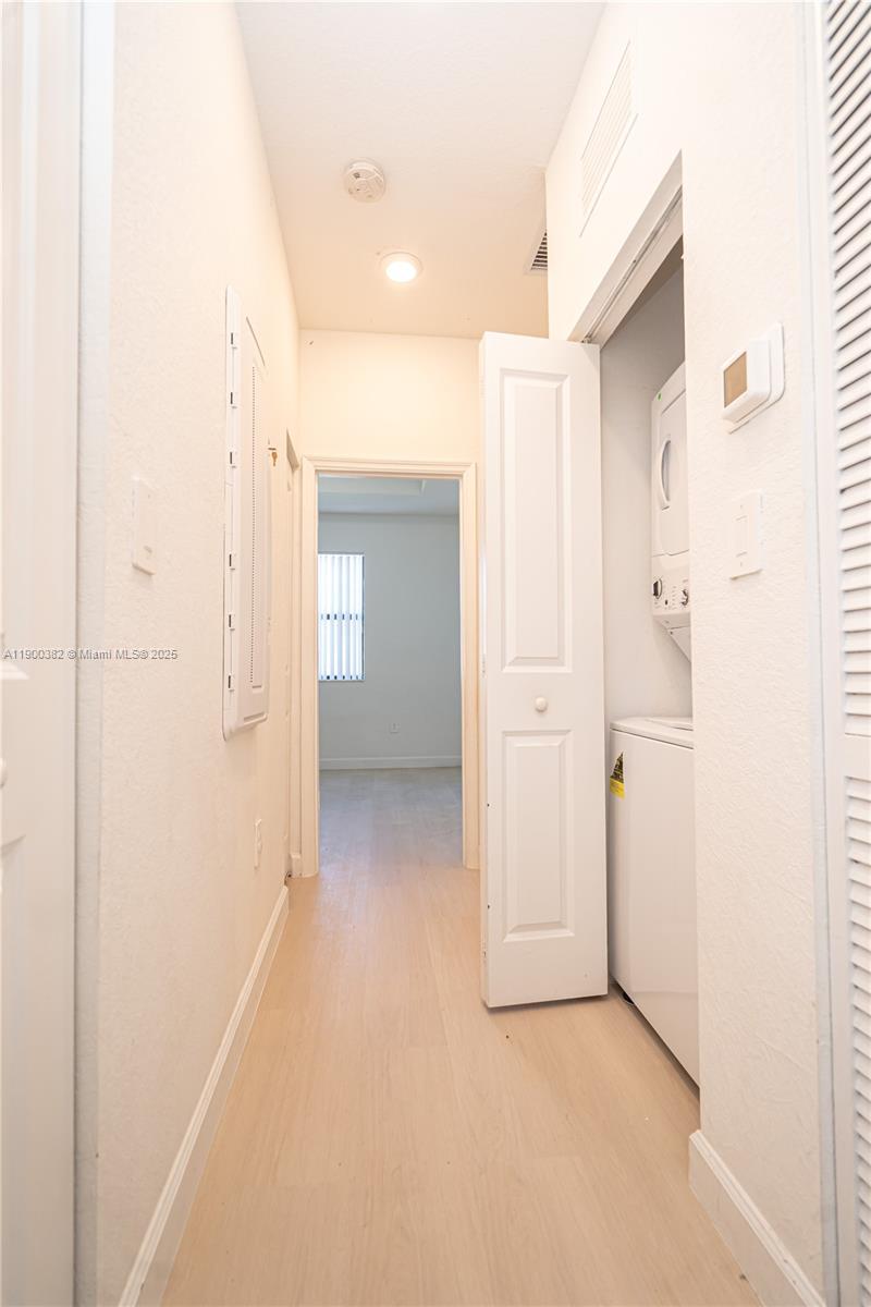 13237 Southwest 286th Street, Unit 13237 Homestead, FL 33033 - Photo 26 of 48 a view of a hallway with wooden shelves