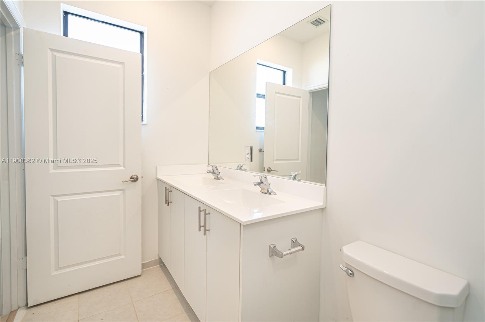 13237 Southwest 286th Street, Unit 13237 Homestead, FL 33033 - Photo 28 of 48 a bathroom with a sink a toilet and a mirror