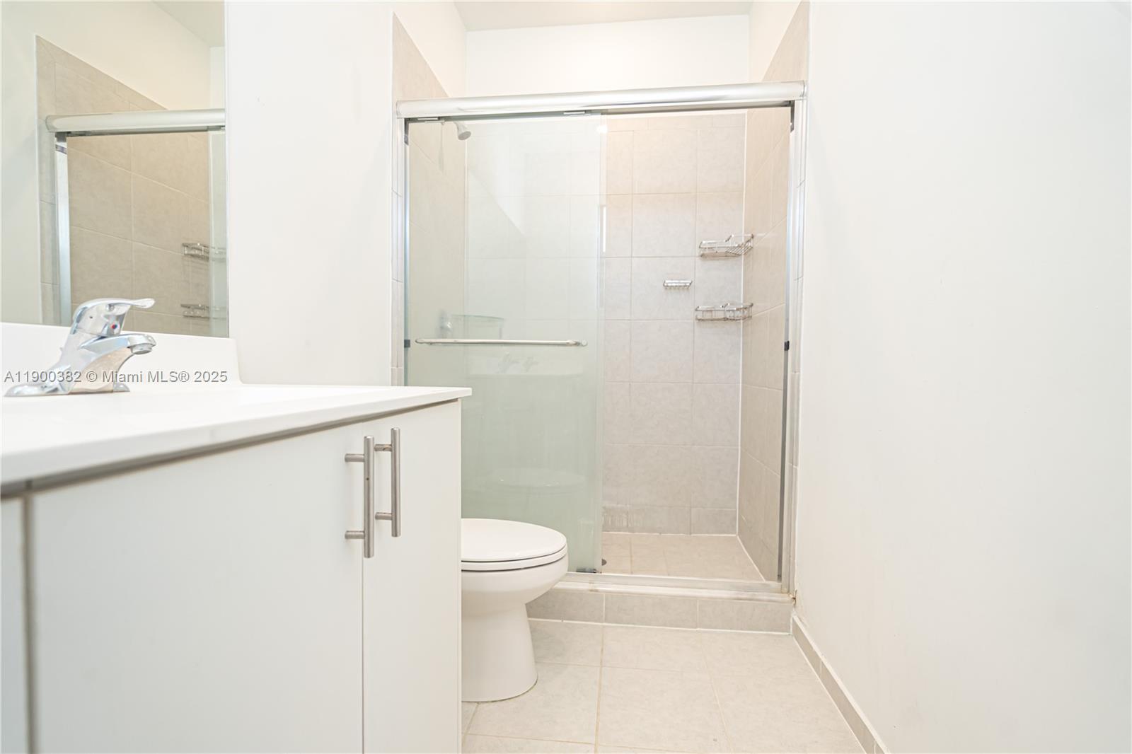 13237 Southwest 286th Street, Unit 13237 Homestead, FL 33033 - Photo 30 of 48 a bathroom with a sink a toilet and shower