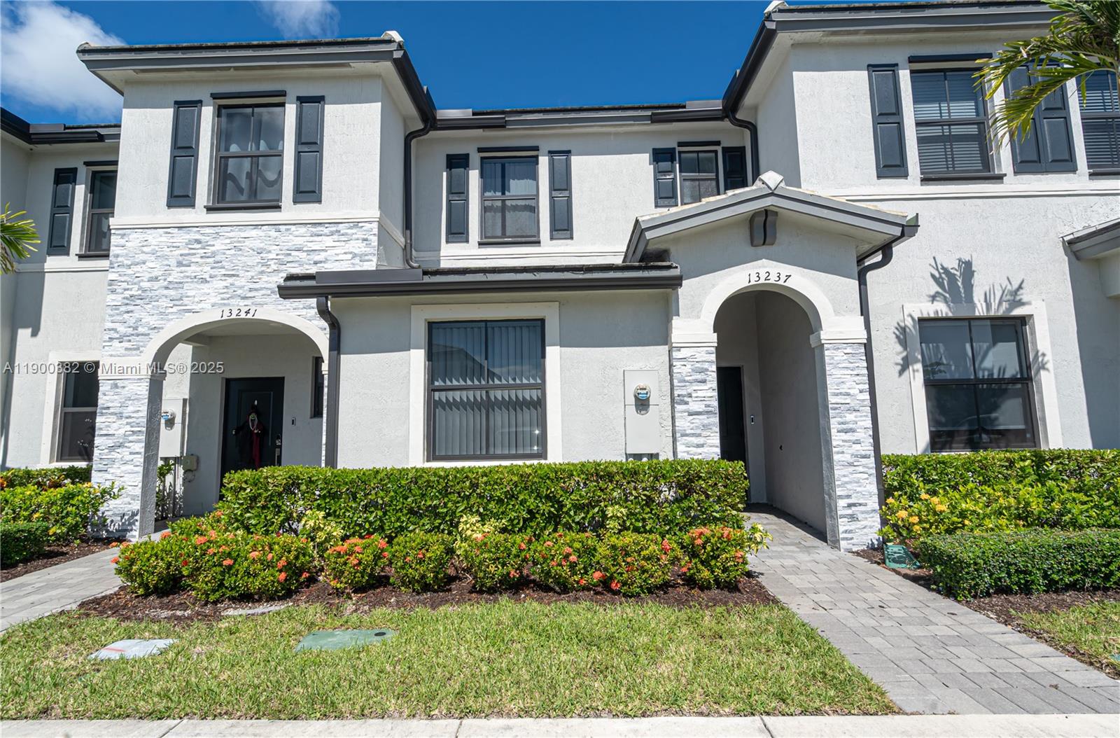 13237 Southwest 286th Street, Unit 13237 Homestead, FL 33033 - Photo 33 of 48 a front view of a house with a garden