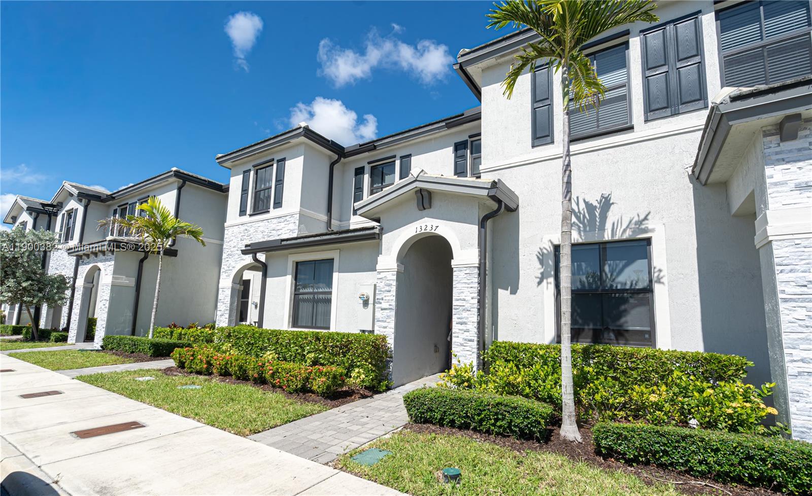 13237 Southwest 286th Street, Unit 13237 Homestead, FL 33033 - Photo 34 of 48 a front view of a house with a garden