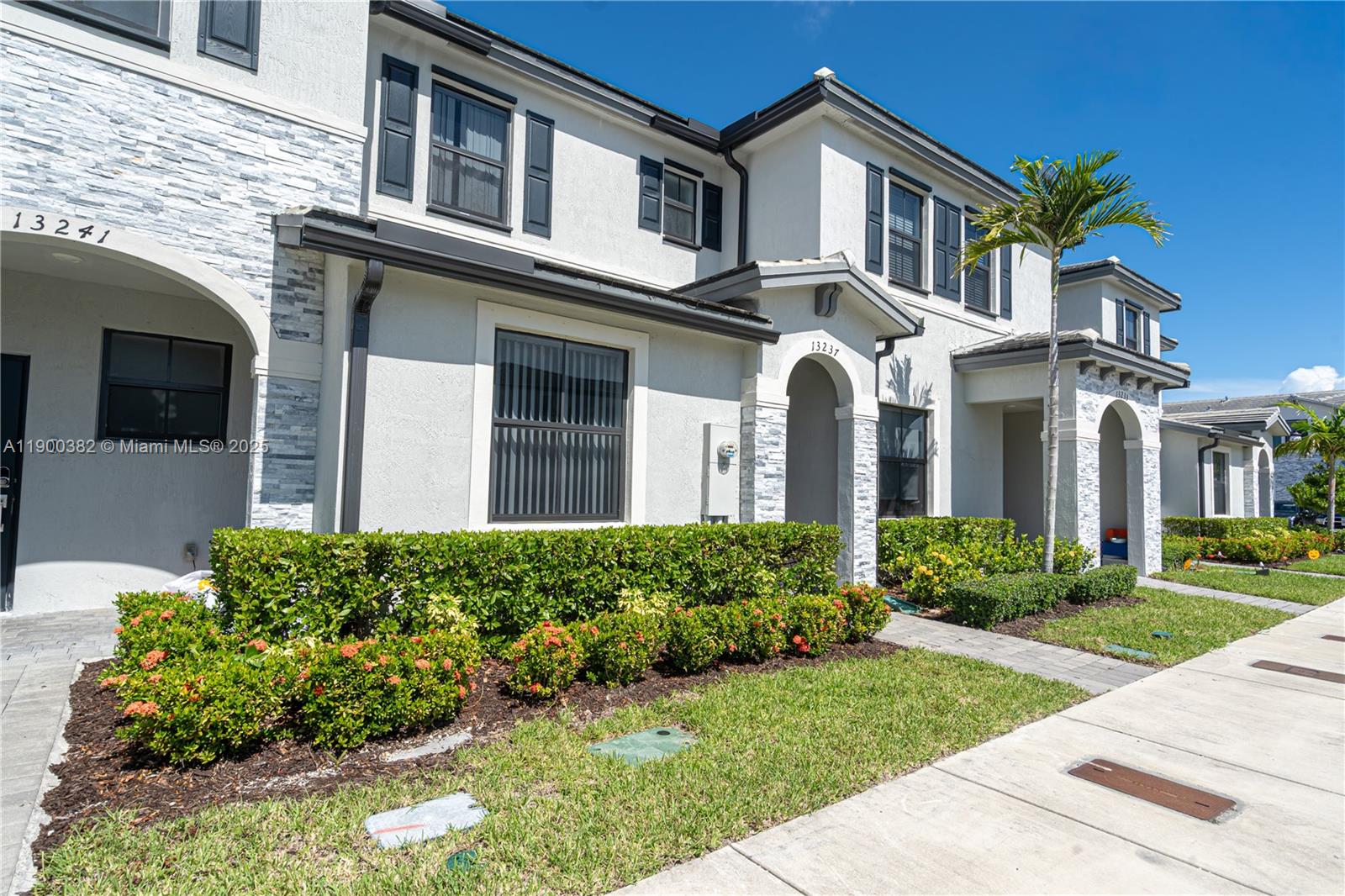13237 Southwest 286th Street, Unit 13237 Homestead, FL 33033 - Photo 35 of 48 a front view of a house with garden