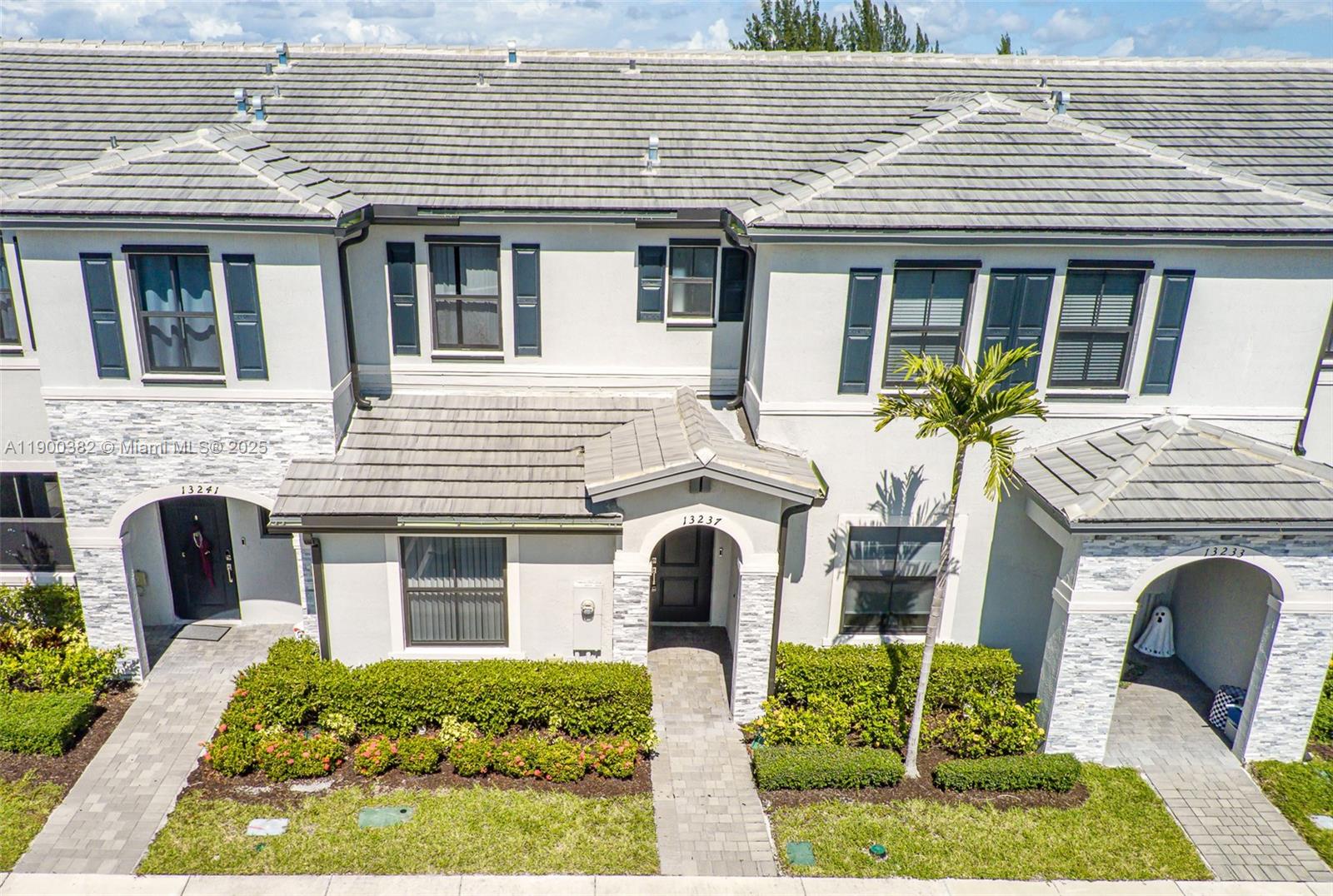 13237 Southwest 286th Street, Unit 13237 Homestead, FL 33033 - Photo 36 of 48 a front view of a house with garden
