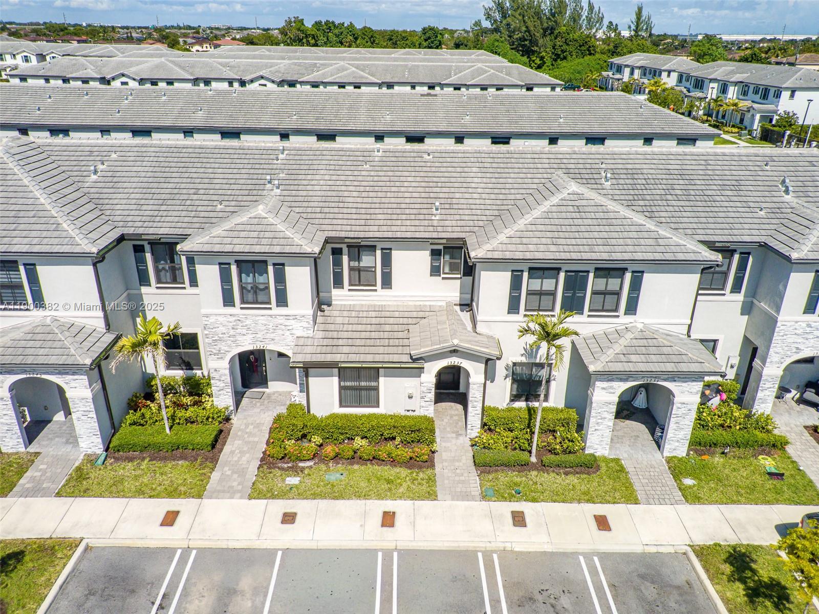 13237 Southwest 286th Street, Unit 13237 Homestead, FL 33033 - Photo 37 of 48 a front view of a house with a garden