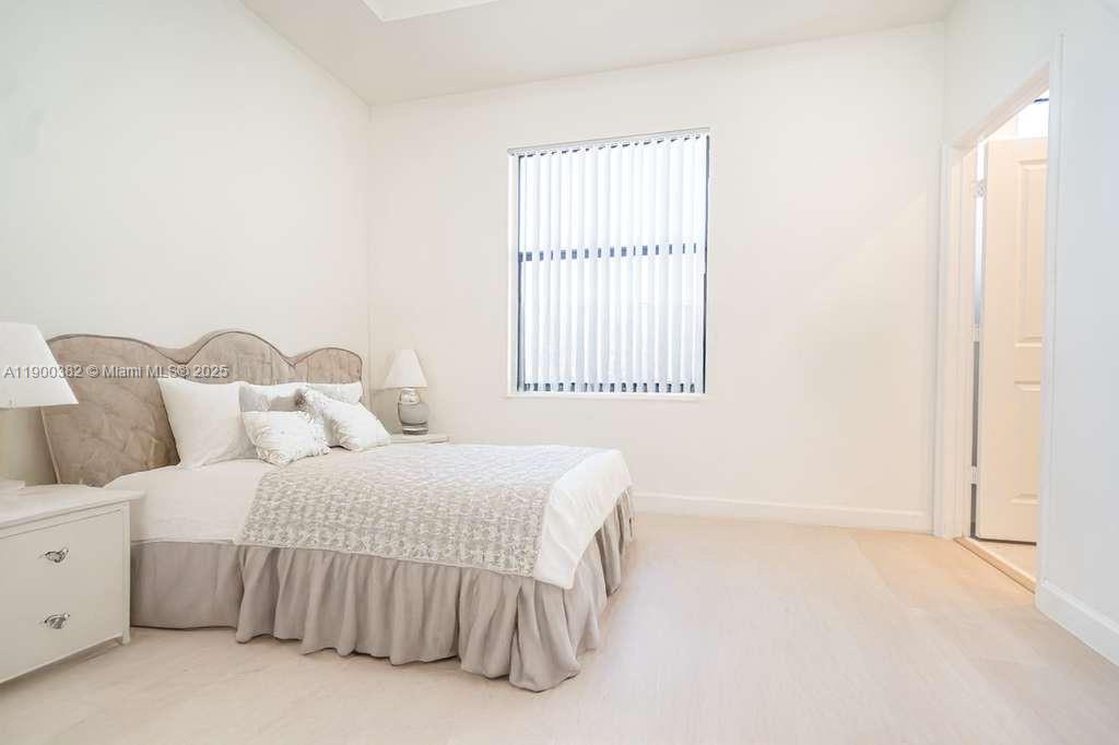 13237 Southwest 286th Street, Unit 13237 Homestead, FL 33033 - Photo 5 of 48 a bedroom with a bed and a window